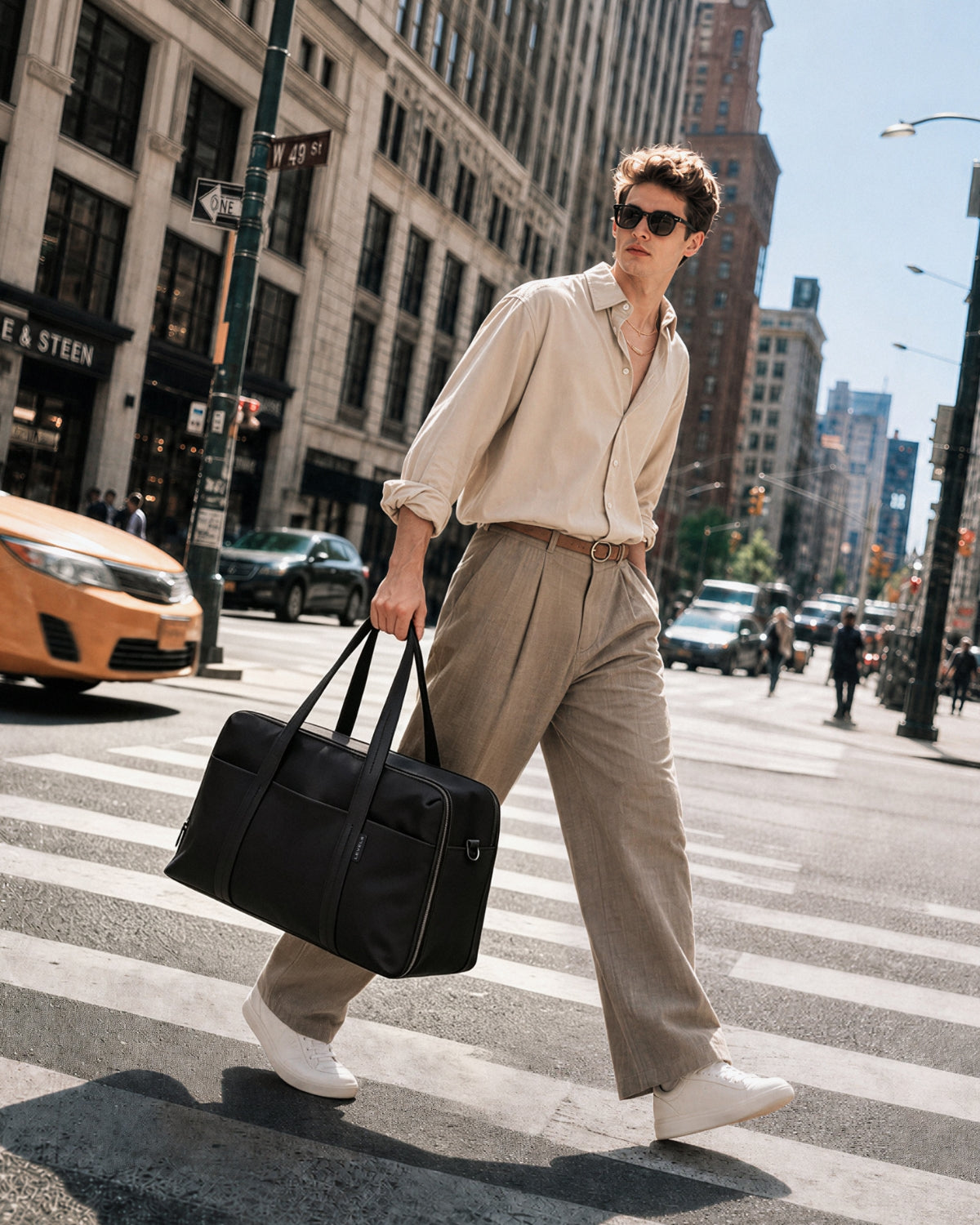 Man commuting on city street carrying LEVEL8 CITYGO Weekender Bag