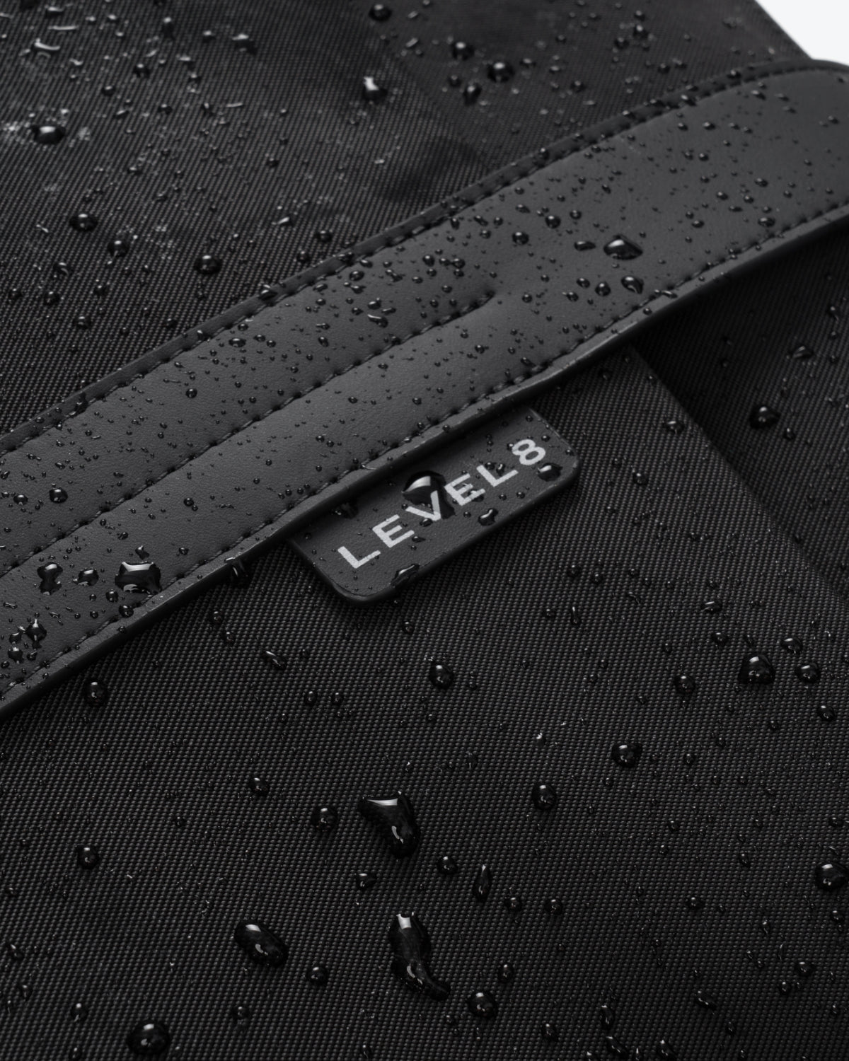 Water-resistant fabric detail with LEVEL8 logo badge on CITYGO Weekender Bag